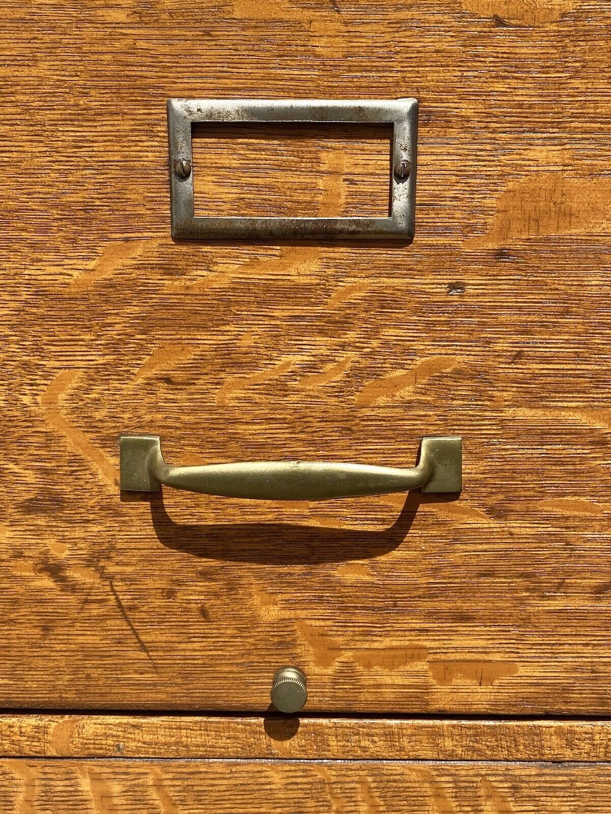 Antique Oak 4 Drawer Wood File Cabinet with double paneled sides and original hardware - photo of hardware showing index card plate, brass pull, & file rods