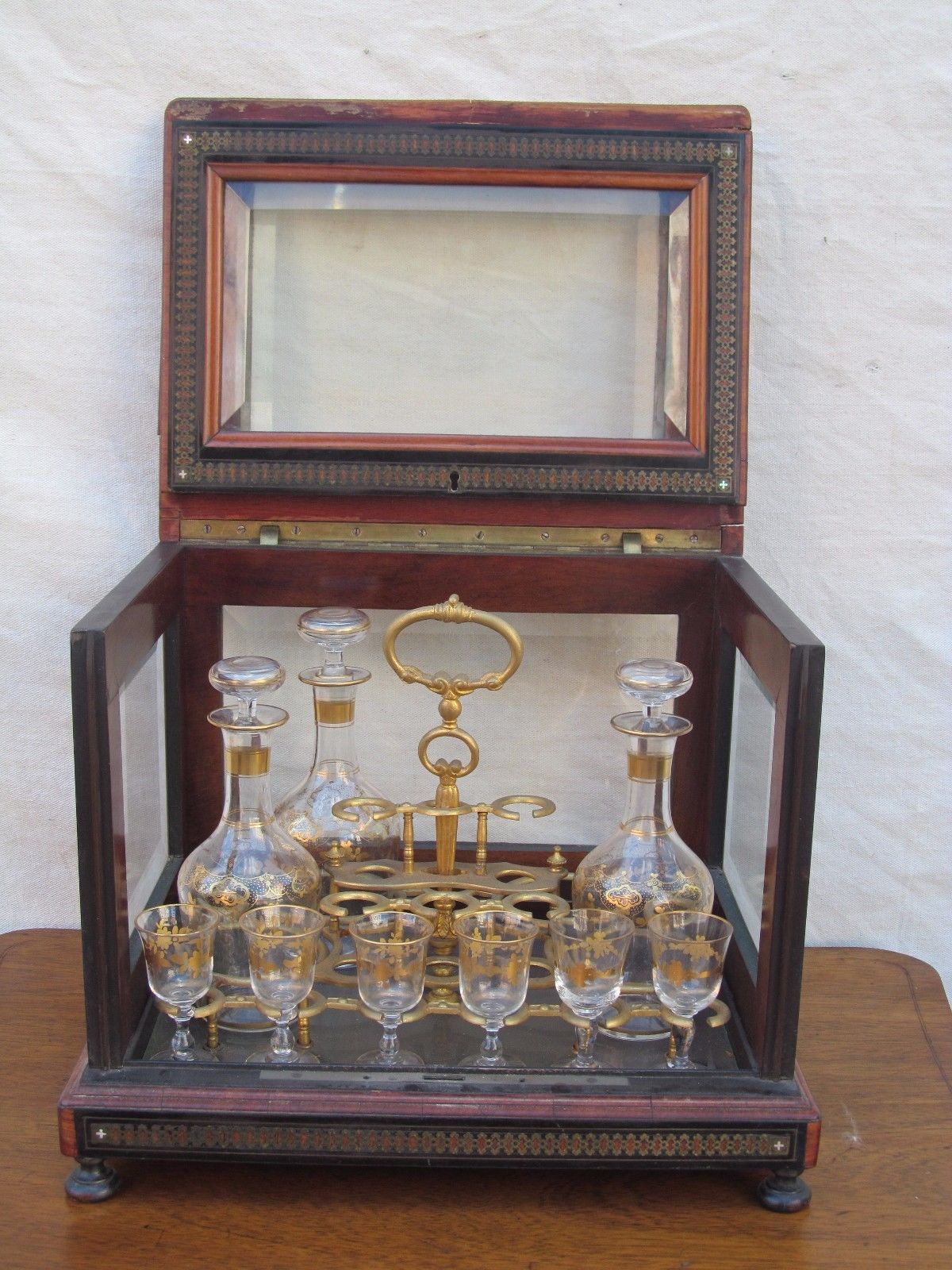 ANTIQUE DECORATED LIQUOR TANTALUS WITH BRASS & ROSEWOOD INLAYS