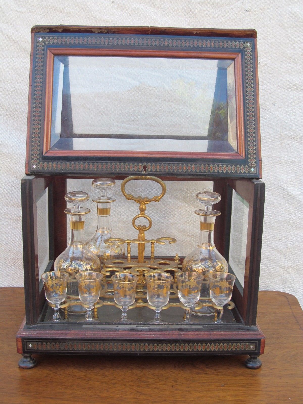 ANTIQUE DECORATED LIQUOR TANTALUS WITH BRASS & ROSEWOOD INLAYS