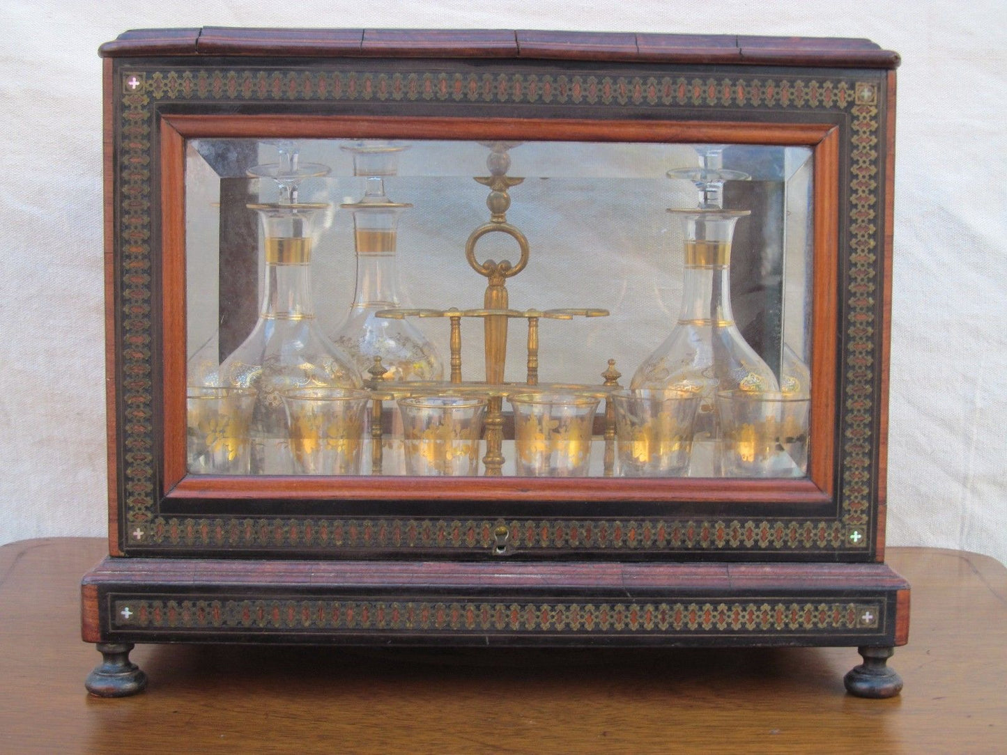 ANTIQUE DECORATED LIQUOR TANTALUS WITH BRASS & ROSEWOOD INLAYS