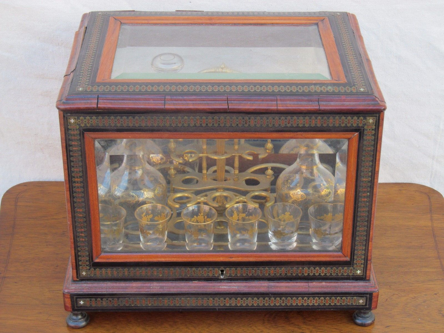 ANTIQUE DECORATED LIQUOR TANTALUS WITH BRASS & ROSEWOOD INLAYS