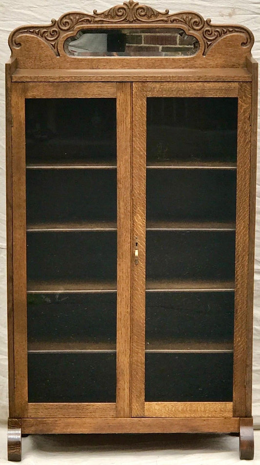 19TH C. VICTORIAN GOLDEN OAK BOOKCASE WITH MIRRORED AND CARVED GALLERY.