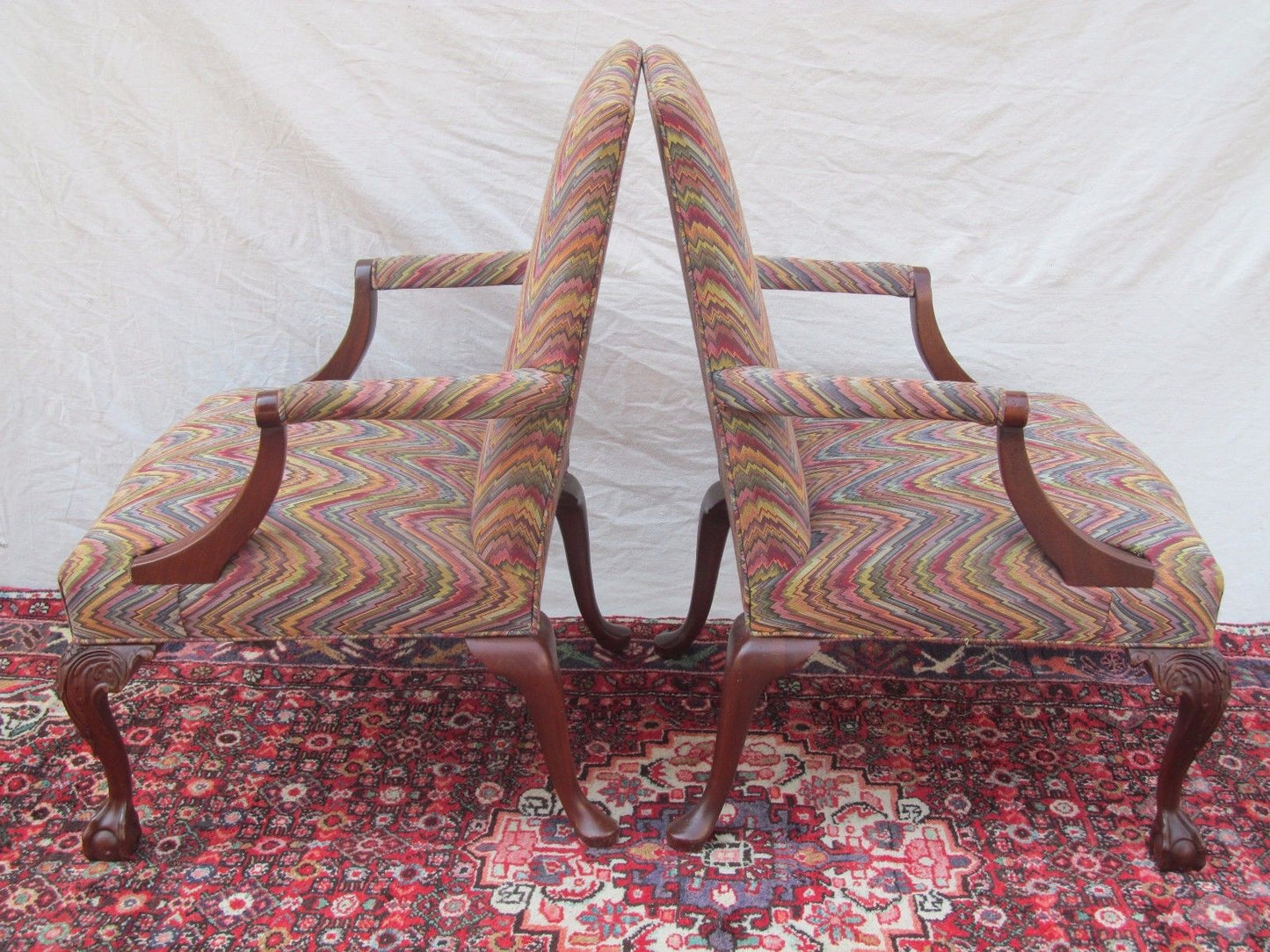 PAIR MAHOGANY CHIPPENDALE STYLED LOLLING CHAIRS W/ BALL & CLAW CARVED LEGS