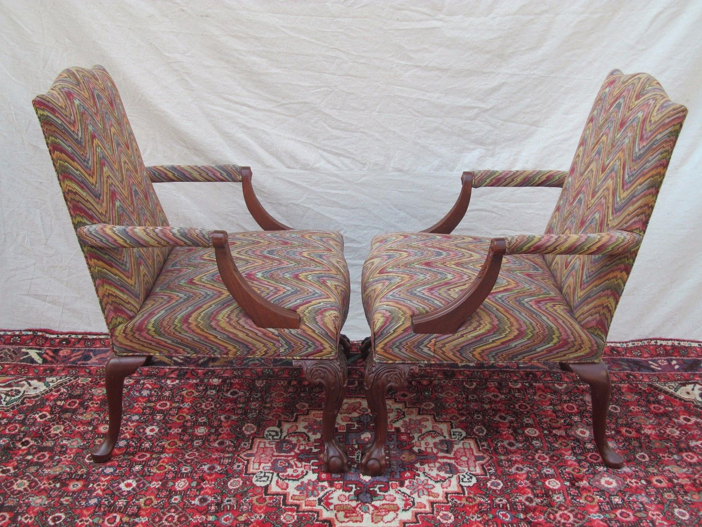 PAIR MAHOGANY CHIPPENDALE STYLED LOLLING CHAIRS W/ BALL & CLAW CARVED LEGS