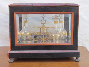 ANTIQUE DECORATED LIQUOR TANTALUS WITH BRASS & ROSEWOOD INLAYS